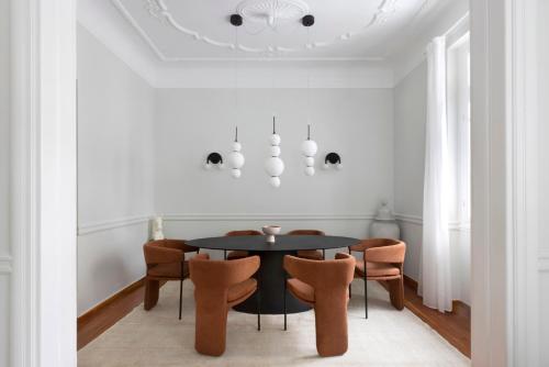 a dining room with a black table and chairs at Acropolis Villa in Athens