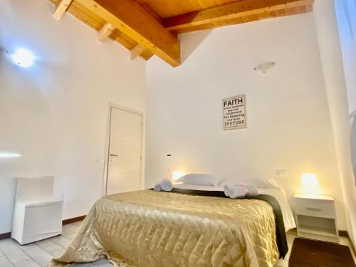 a bedroom with a bed in a white room at In Love 01 in Montichiari