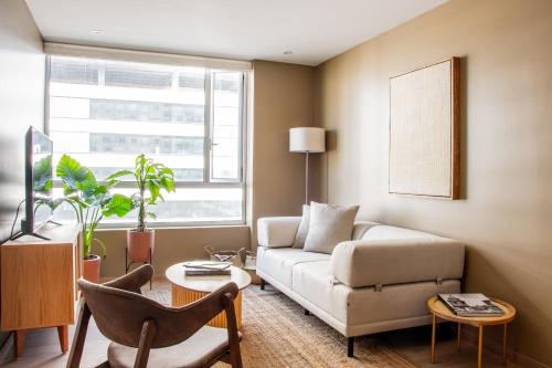 a living room with a couch and a chair at Japandi style apartment in Polanco in Mexico City