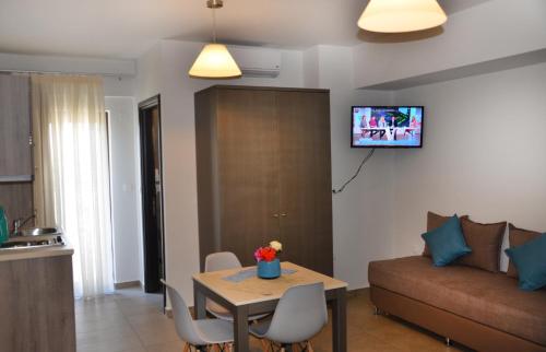 a living room with a table and a couch at Ledra Maleme Hotel in Maleme