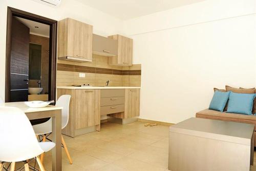 a kitchen with a sink and a table in a room at Ledra Maleme Hotel in Maleme