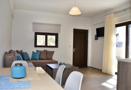 a living room with a couch and a table at Ledra Maleme Hotel in Maleme