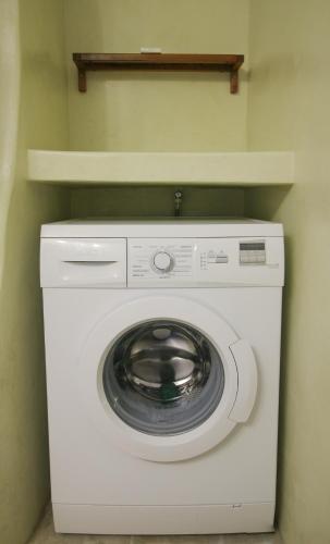 a washer and dryer in a corner of a room at Villa with View of Agios Ioannis and Pool with Jacuzzi in Agios Ioannis Tinos