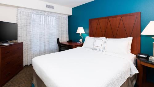 a hotel room with a large bed and a tv at Residence Inn by Marriott Baton Rouge near LSU in Baton Rouge