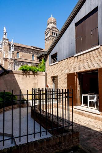 a building with a fence in front of it at Ca' Tintoretto in Venice