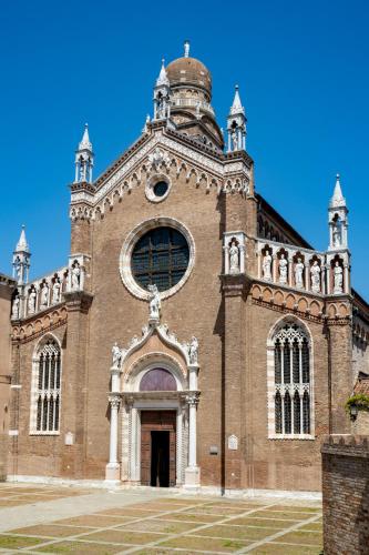 a large brick church with a tower on top at Ca' Tintoretto in Venice