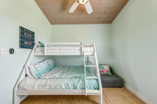 a white bunk bed in a room with a ceiling at Eskridge Gem Unit B in Port Aransas
