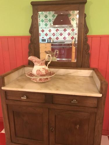 a wooden dresser with a mirror and a bowl on it at Basarte Cottage in Bakio