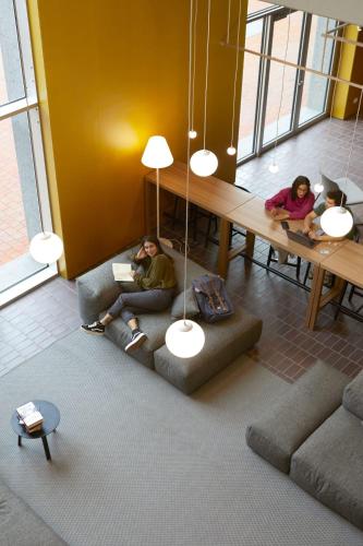 two people sitting on couches in a living room at aparto Milan Giovenale in Milan
