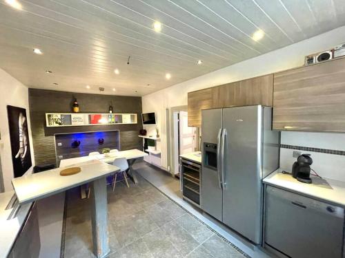 une cuisine avec un réfrigérateur et une table à l'intérieur dans l'établissement Spacious apartment in the heart of the center, à Riquewihr