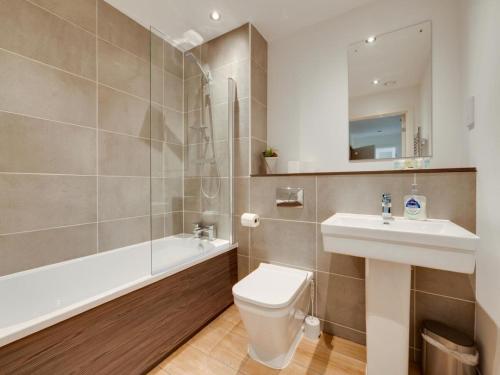 a bathroom with a toilet and a sink and a shower at Modern 2 Bedroom Apartment Manchester Media City in Manchester