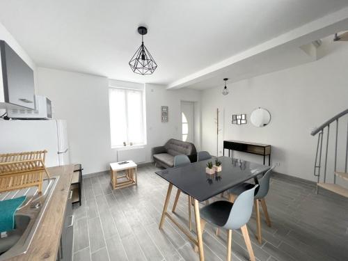 une cuisine et un salon avec une table et des chaises dans l'établissement 180A - Duplex T2 Tout Confort du Gond - 45 m2, à Le Gond-Pontouvre