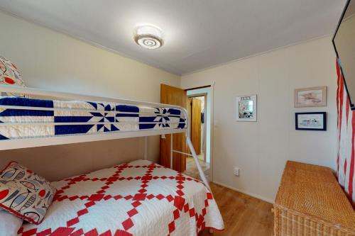 a bedroom with a bunk bed and a staircase at Sea Shanty 960 in Hatteras
