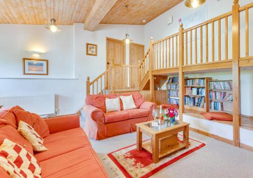 a living room with a couch and a table at Swallow Barton in Atherington