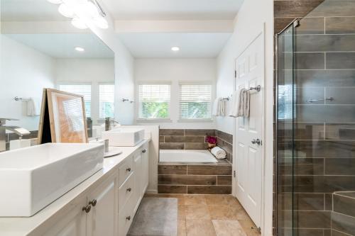 a bathroom with two sinks and a shower at Sunset Villa - Walk To Koolina Beaches - Sleeps 8 in Kapolei