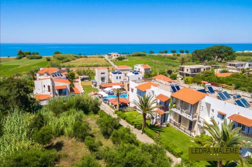 an aerial view of a house with the ocean in the background at Ledra Maleme Hotel in Maleme