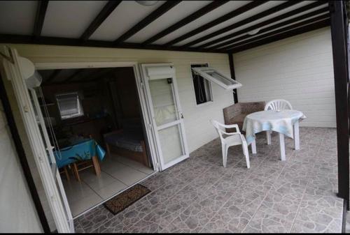 a patio with a table and chairs on a house at Gîte le Fouquet in Cilaos