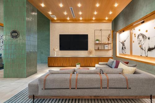 a living room with a couch and a flat screen tv at Sentral Union Station in Denver