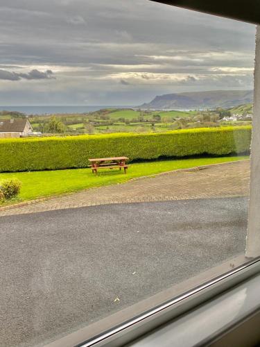 a bench sitting on the side of a road at Cullentra House in Cushendall