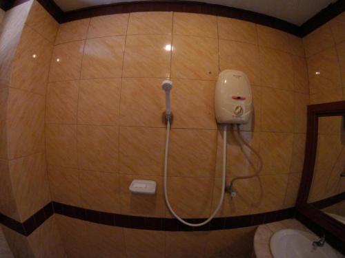a shower in a bathroom with a toilet at Kraisaeng Place in Phitsanulok