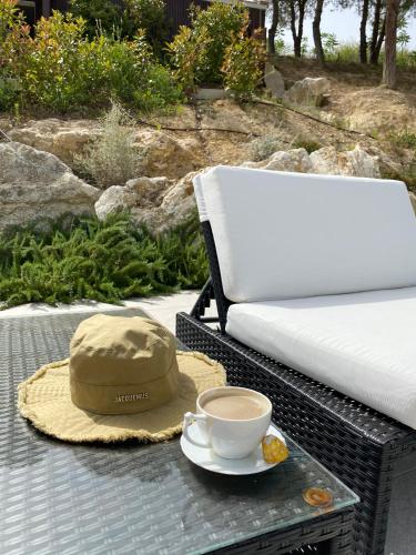 a hat and a cup of coffee on a table at GreenValley BnB in Lapedona