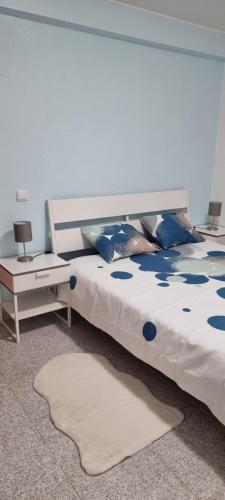 コスタ・ダ・カパリカにあるApartamento Capa Ricaのベッドルーム(青い枕の大型ベッド1台付)