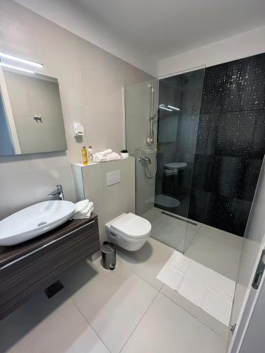 a bathroom with a sink and a toilet and a shower at Luxury apartment Mon Soleil in Murter