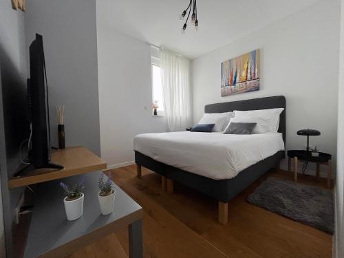 a bedroom with a bed and a television in it at Luxury apartment Mon Soleil in Murter