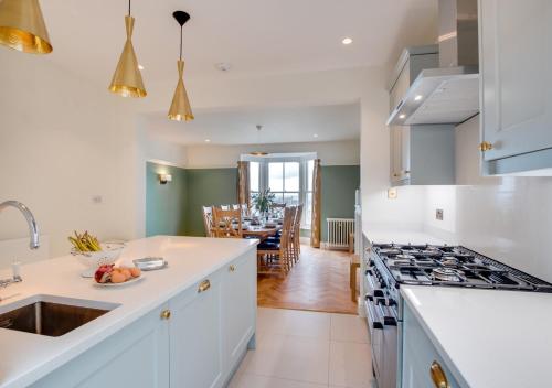 a kitchen with a sink and a stove at St Agnes Sleeps 6 in Ilfracombe