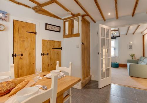 a kitchen and dining room with a table and chairs at Temperance Cottage in Braunton