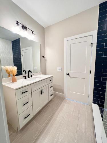 a bathroom with a sink and a mirror at Swanky Seahorse in Carolina Beach