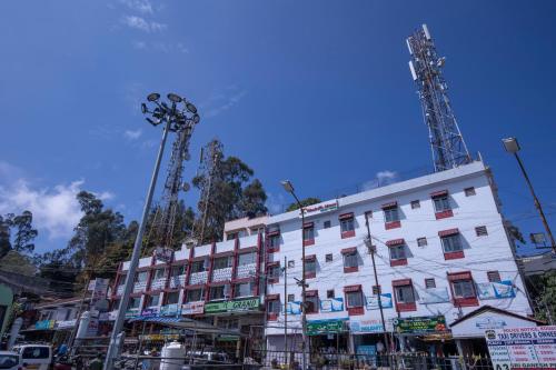 a large white building with antennas on top of it at JC Woodville Manor in Kodaikānāl