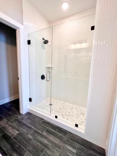 a shower with a glass door in a bathroom at Swanky Seahorse in Carolina Beach