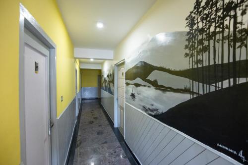 a hallway with a painting on the wall at JC Woodville Manor in Kodaikānāl