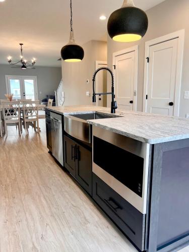a kitchen with a sink and a counter top at Swanky Seahorse in Carolina Beach