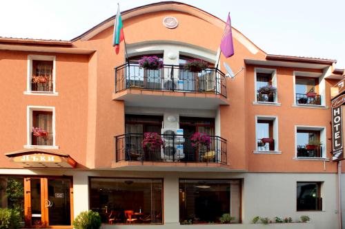 a building with flowers on the balconies of it at Lucky Hotel in Veliko Tŭrnovo