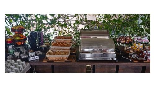 a table with baskets of bread and other food on it at Hotel Crystal Light in Niš
