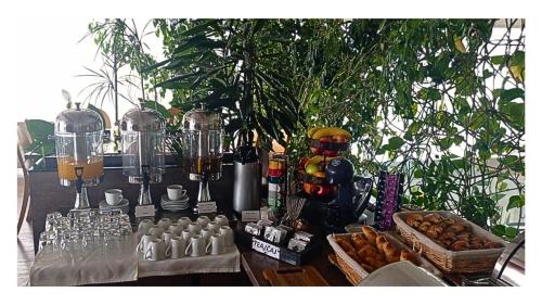 a table with food and drinks on it at Hotel Crystal Light in Niš