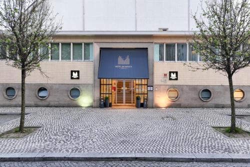 a building with a sign on the front of it at Hotel da Música in Porto