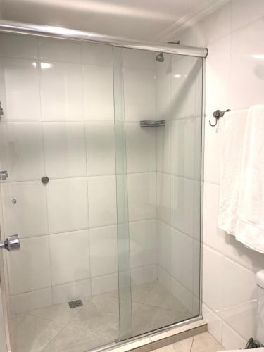 a shower with a glass door in a bathroom at Apart Hotel Centro de Brasília (Garvey Park Hotel) in Brasilia