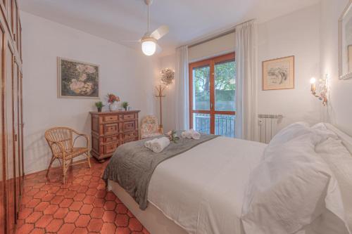 a bedroom with a bed and a chair and a window at RAPALLO APARTMENT Comodo e in Ottima Posizione in Rapallo