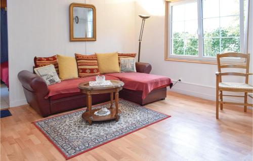 a living room with a couch and a table at Cozy Home In Lestre With Wifi in Quinéville