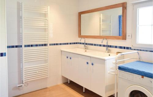 a bathroom with a sink and a mirror at Cozy Home In Lestre With Wifi in Quinéville