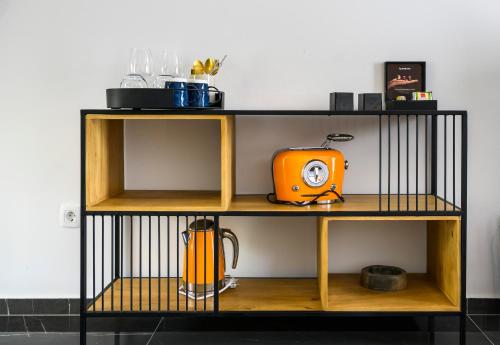 a shelf with an orange toaster on it at Gallery Luxury Suites & Rooms-Only Adults in Split