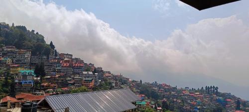 a hillside with a bunch of houses on a mountain at Tea corner Guest house in Darjeeling