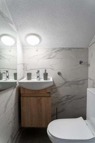 a bathroom with a sink and a toilet at Danai Maisonettes Ofriniou in Ofrínion