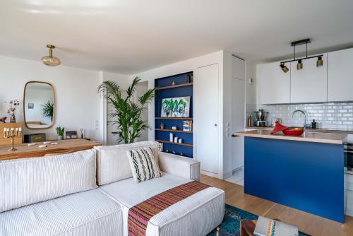 sala de estar con sofá y cocina en Stunning apartment with balcony to visit Paris en París