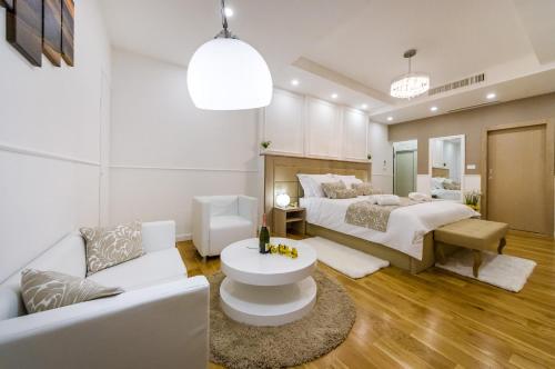 a bedroom with two beds and a couch at Peninsula Luxury Suite in Zadar