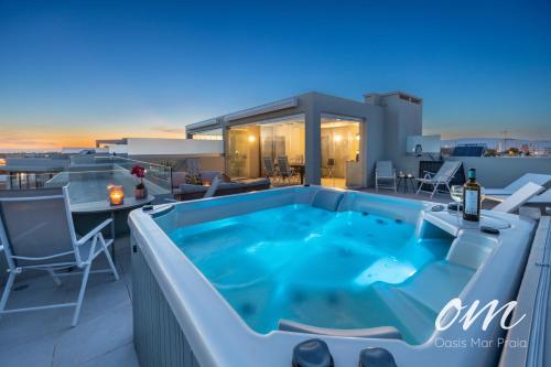 a hot tub on the roof of a house at Oasis Mar Praia - Penthouse with private seaview Jacuzzi in Portimão