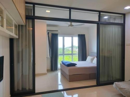 a bedroom with a bed and a large window at MyHome S1 At Seri Kembangan With A View in Seri Kembangan
